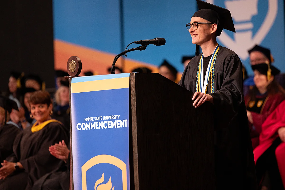 graduate stands at podium