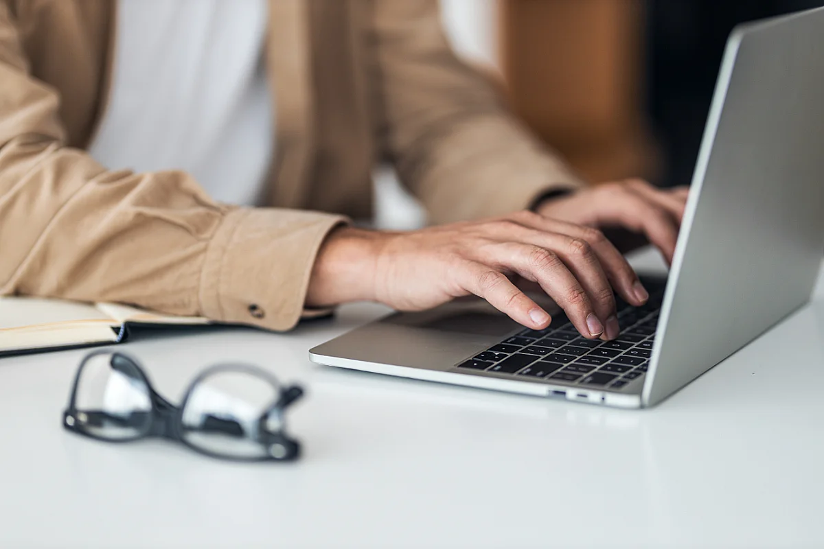 person typing on laptop
