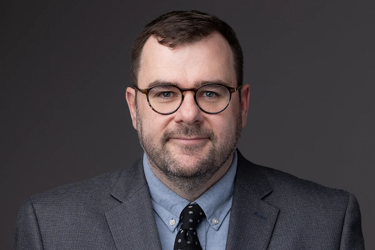 professional headshot of a man in suit