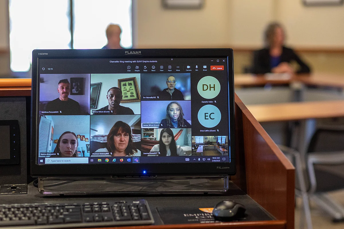 Photo of a computer screen with multiple students engages in a virtual online session.