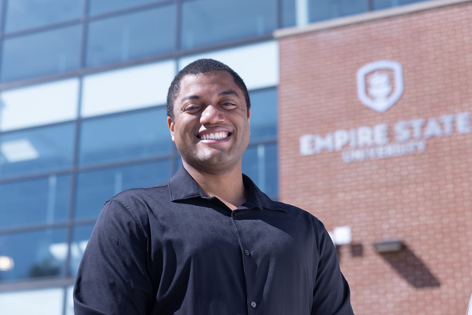student standing outside SUNY Empire building
