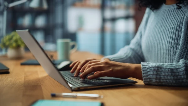 photo of person typing on laptop