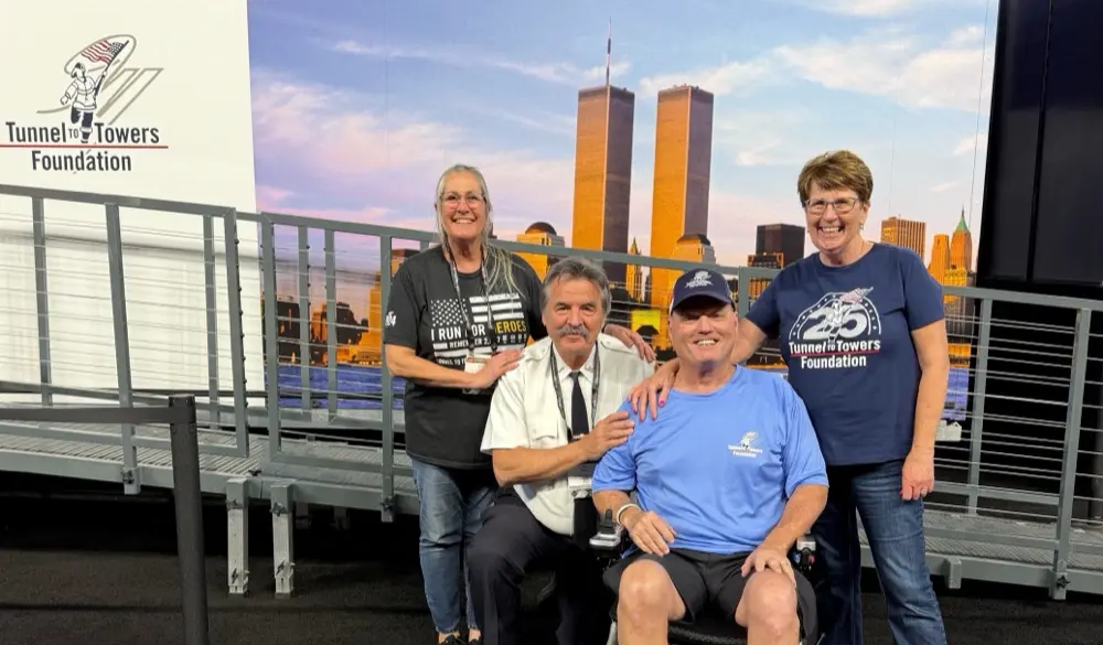 Eaton, left, with retired FDNY Lt. Pat Clancy, and veteran Martin Lathrop and his wife Tany, beneficiaries of the Tunnel to Towers Smart Home Program. 