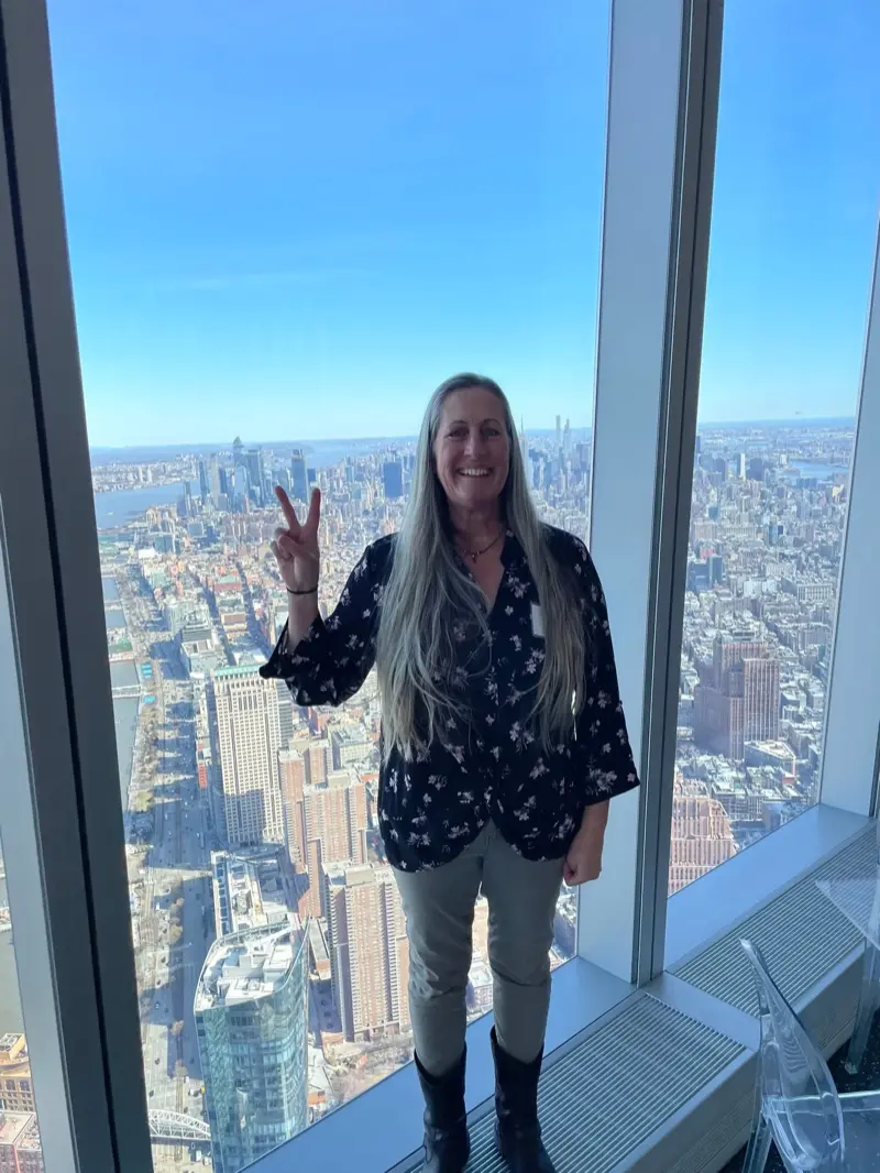 Eaton makes the peace sign on the 102nd floor of the Freedom Towers, at the annual Tower Climb. (Photo credit: Teyonte Best)