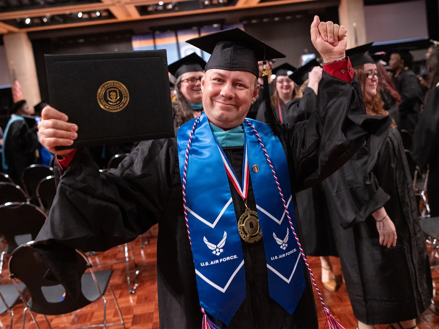 Student celebrating with a diploma after graduating