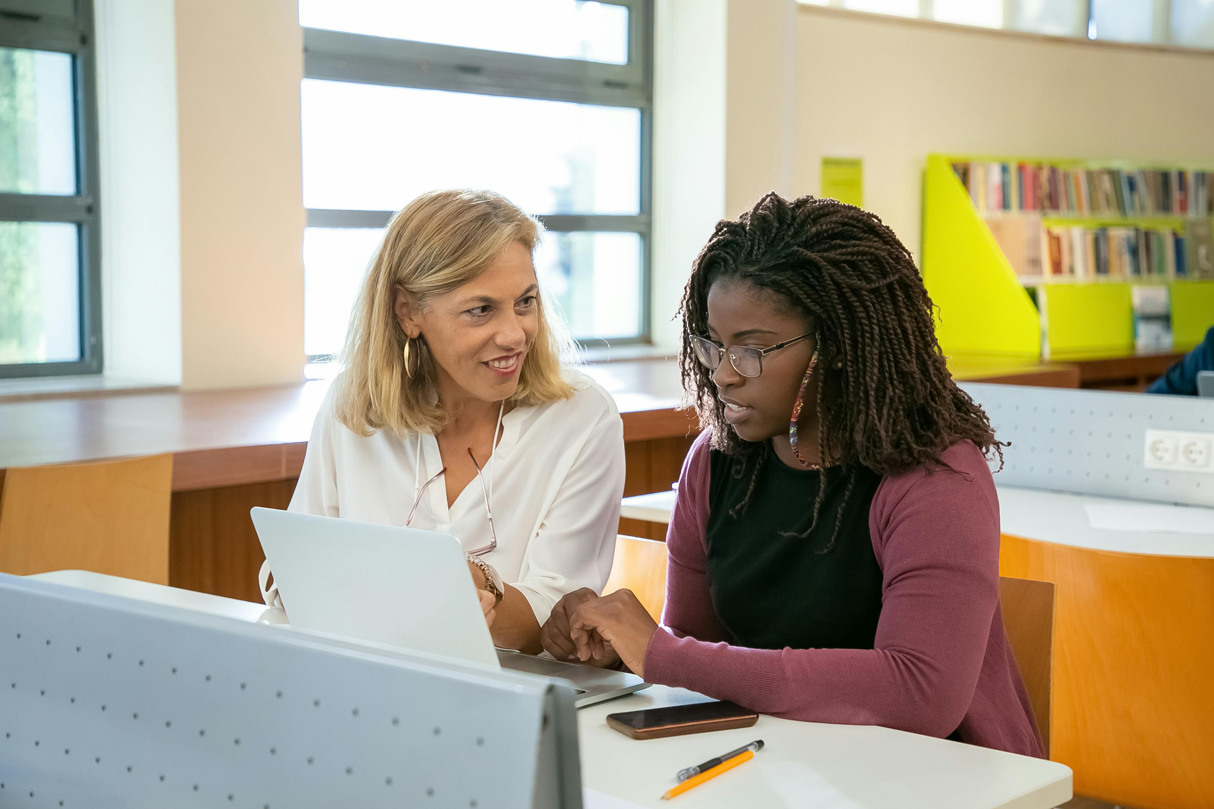 Two people learning together at a desk.