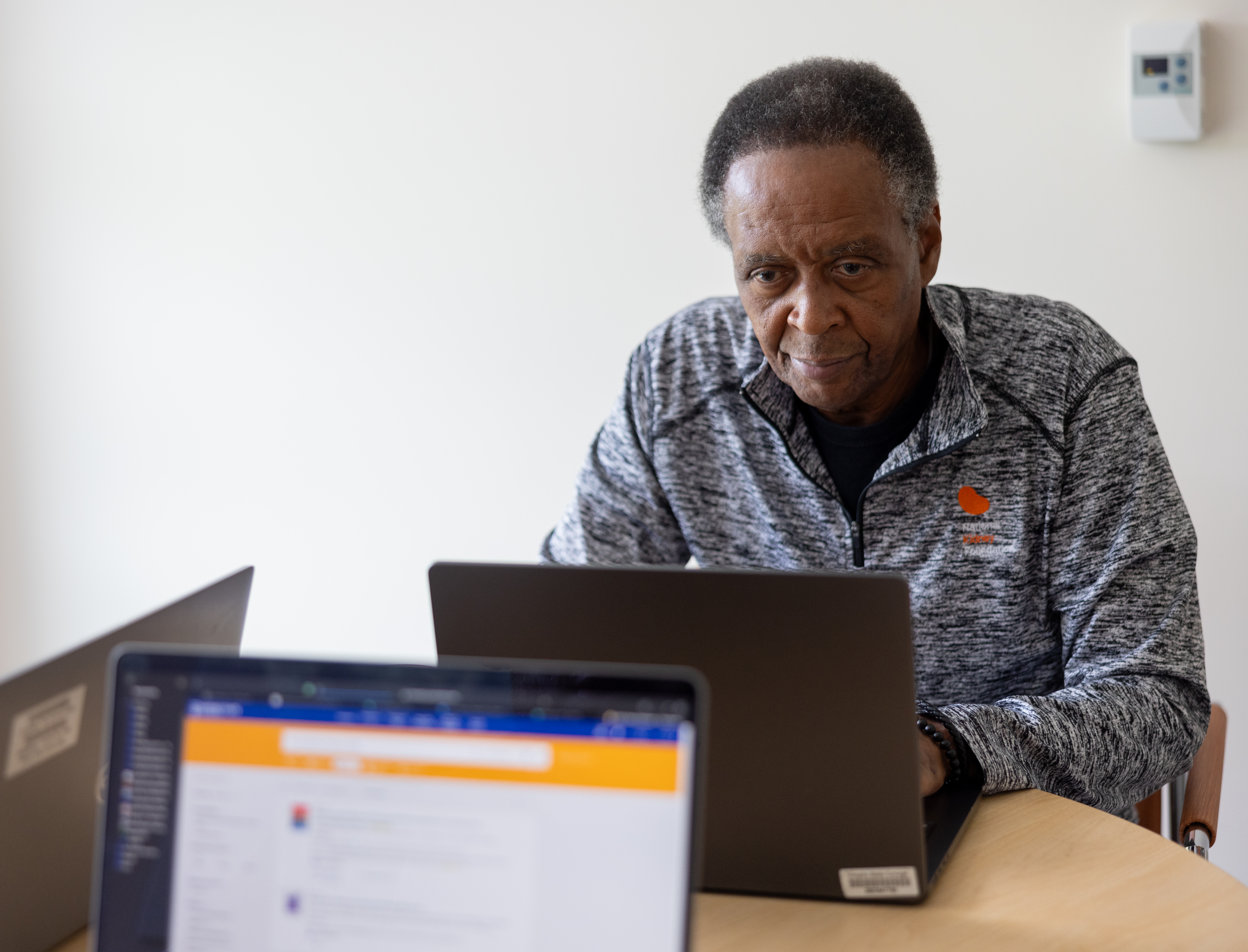 Man works at a laptop computer.